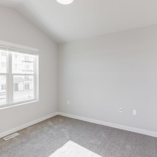 Bedroom with carpet flooring at Union Court Senior Apartments and Townhomes in Kenosha, Wisconsin