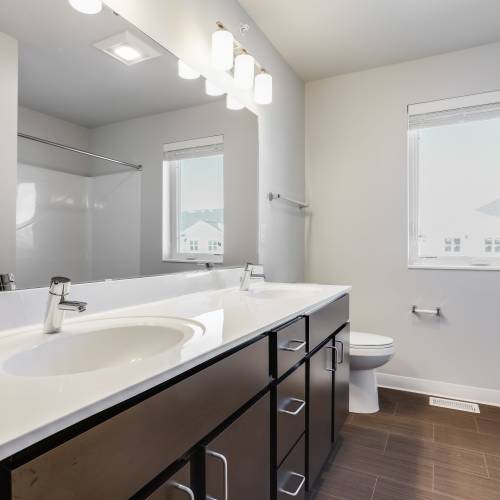 Bathroom with vanity mirror at Union Court Senior Apartments and Townhomes in Kenosha, Wisconsin