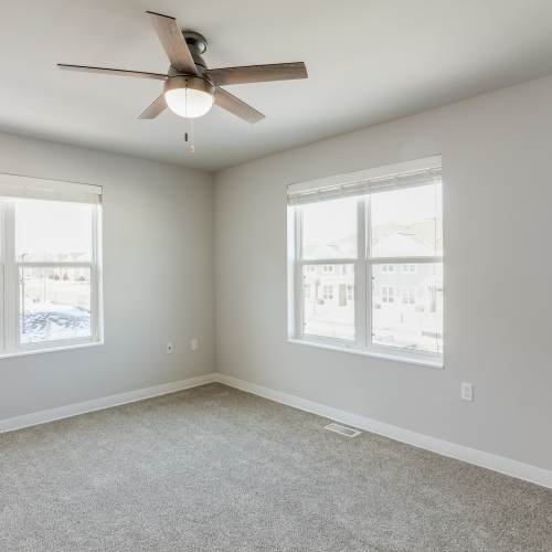 Bedroom with ceiling fan at Union Court Senior Apartments and Townhomes in Kenosha, Wisconsin