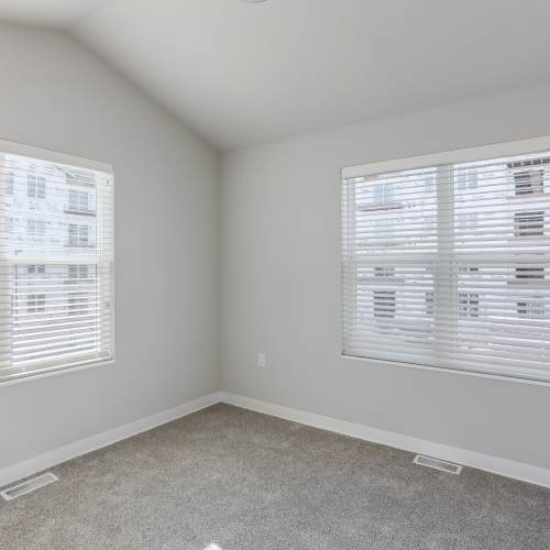 Bedroom with two window at Union Court Senior Apartments and Townhomes in Kenosha, Wisconsin