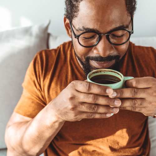 A resident enjoying his morning coffee in his apartment home at Waterford Place Apartments in Mesa,Arizona