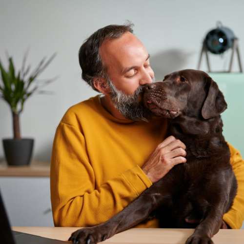Man with dog at Legends 267 Apartments in Kansas City, Kansas
