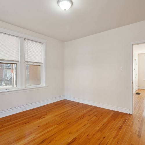 Unfurnished bedroom with large windows in a model home at Central West End Apartments in Saint Louis, Missouri