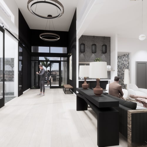 Spacious lobby with contemporary furniture and pendant lights at Evergreen Westside in Gainesville, Florida.