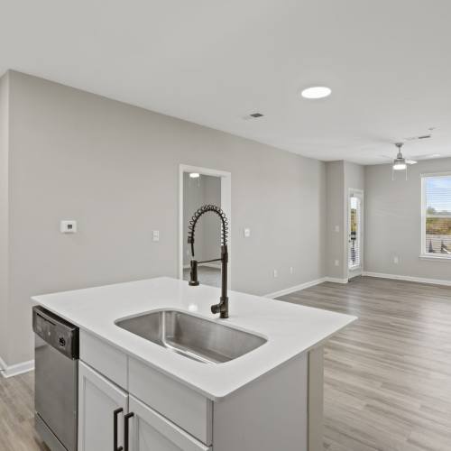 View of the living room from the kitchen at Flatiron West Trade in Charlotte, North Carolina