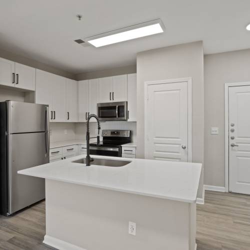 Kitchen with refrigerator at Flatiron West Trade in Charlotte, North Carolina