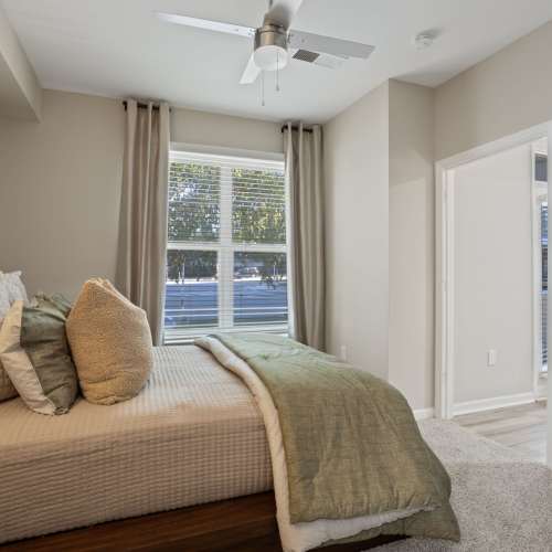 Bedroom with a large window at Flatiron West Trade in Charlotte, North Carolina