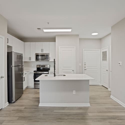 Kitchen with wooden cabinets at Flatiron West Trade in Charlotte, North Carolina