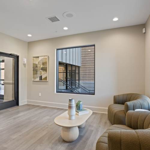 Leasing office with a comfortable couch at Flatiron West Trade in Charlotte, North Carolina