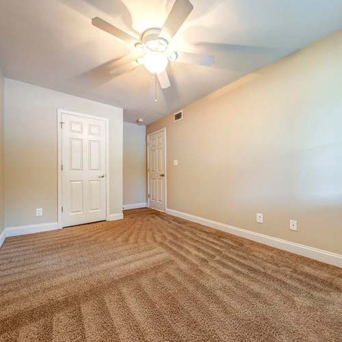 Bedroom with carpet flooring and ceiling fan at Stanton Oaks in Atlanta, Georgia