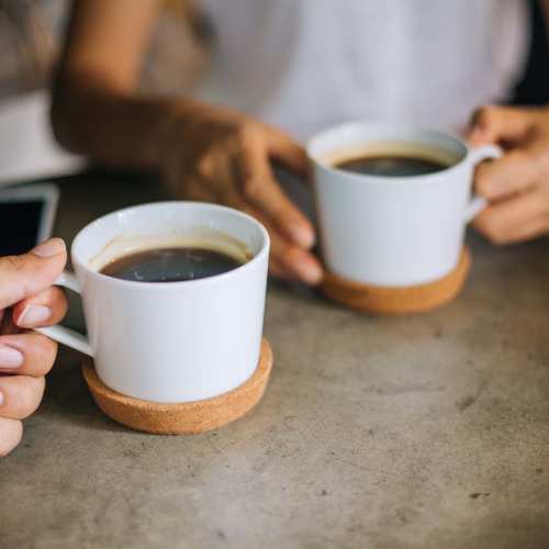 Two white coffee cups on a table at Terrace at Southern Oaks in Dallas, Texas