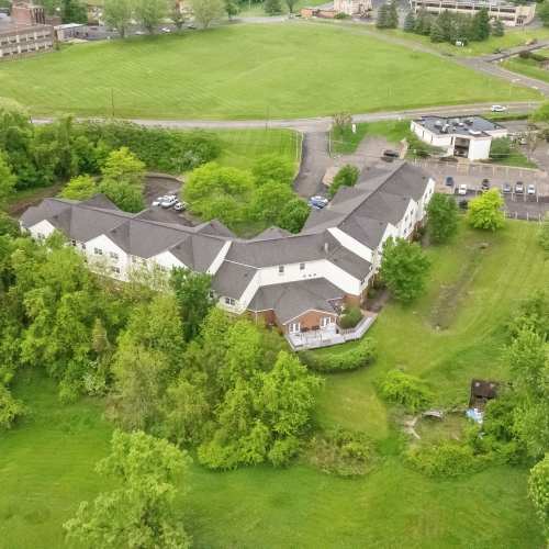 Aerial view of apartment community surrounded by greenery and open fields at Heritage Village in Steubenville, Ohio