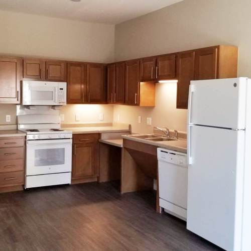 Kitchen with wooden cabinets at The Livingston in Columbus, Ohio