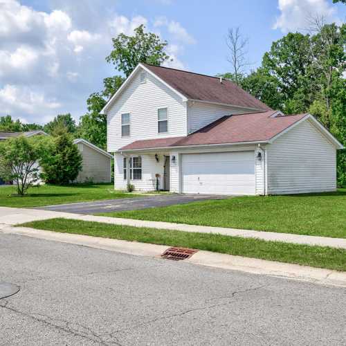 Two-story home with garage and lawn at Chartwell Greene in Mount Gilead, Ohio