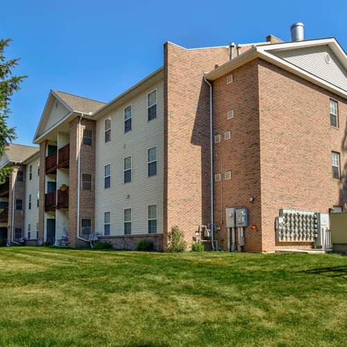 Building exterior with landscaped lawn at Tall Trees in Tiffin, Ohio