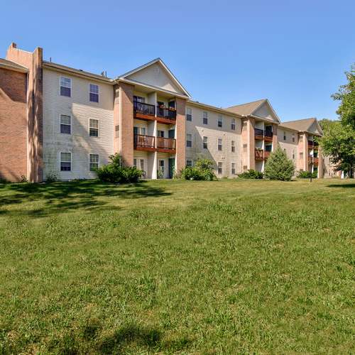 Apartment building exterior with green lawn at Tall Trees in Tiffin, Ohio