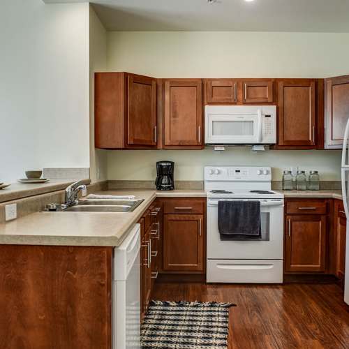 Modern kitchen with granite countertops at Everts Hill Senior Living Apartments in Circleville, Ohio