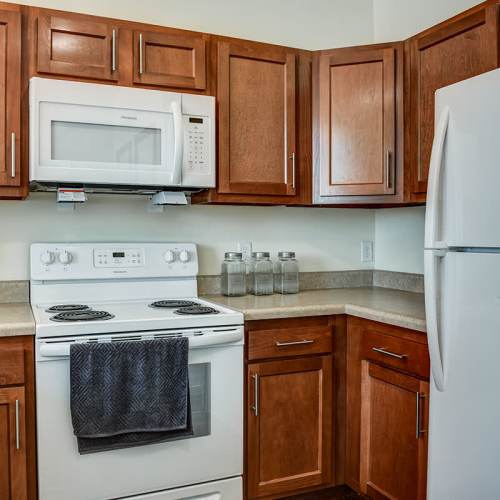 Kitchen with granite countertops and white appliances at Everts Hill Senior Living Apartments in Circleville, Ohio
