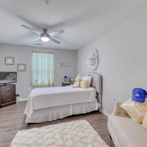 Cozy bedroom with twin bed and ceiling fan at Harbor Meadows in Calabash, North Carolina