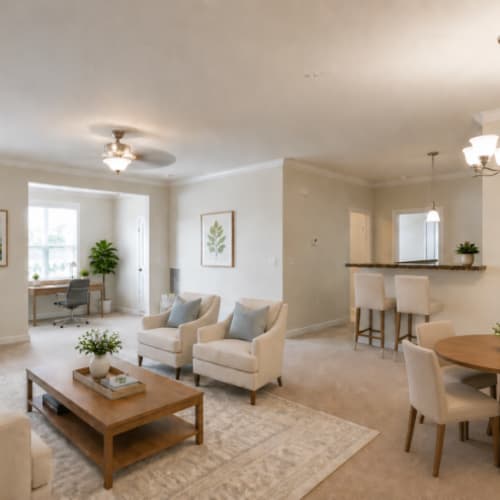 Furnished dining room, and living room leading into the sunroom at Seasons at Cane Creek in Fletcher, North Carolina