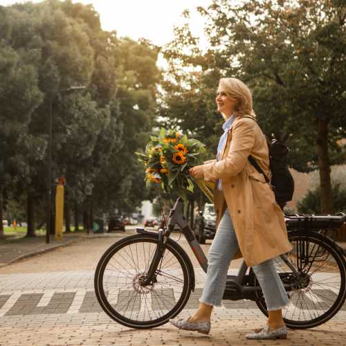 Resident walking with her bi-cycle near Williston Pointe in Gainesville, Florida