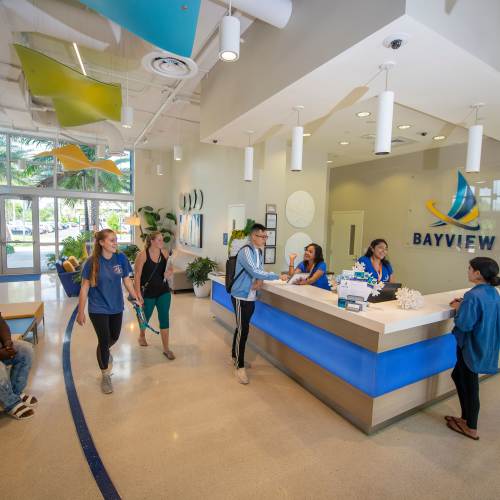 Bright and welcoming leasing office with friendly staff assisting residents and visitors at Bayview Student Living in North Miami, Florida