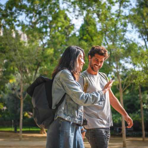 Smiling couple walking in park near Bayview Student Living in North Miami, Florida