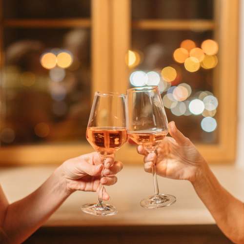 Gated two glasses of rosé clinking together at Chapel Creek in Mandeville, Louisiana