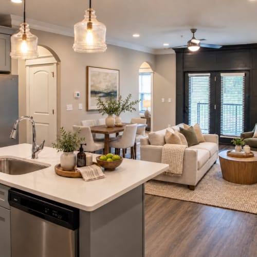 Fully equipped kitchen with stainless steel appliances like a refrigerator, stove, and drawer microwave at West Edge in Lynchburg, Virginia