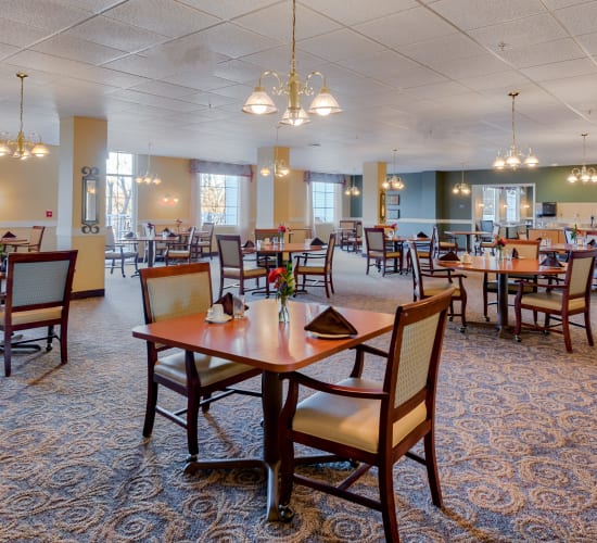 Dining room with tables at Amira Choice Champlin in Champlin, Minnesota. 