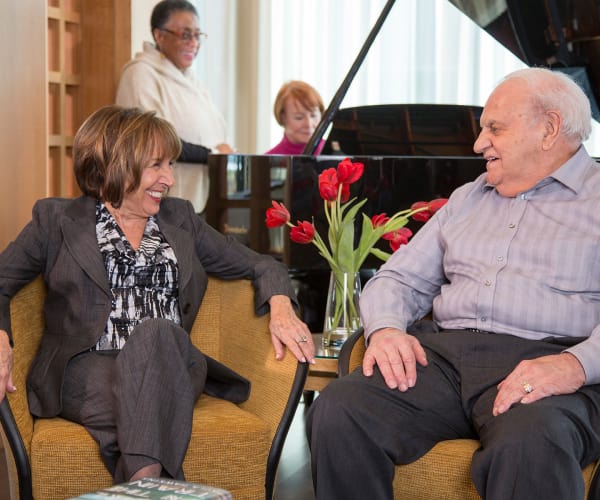 Residents enjoying some lovely piano music at All Seasons Naples in Naples, Florida