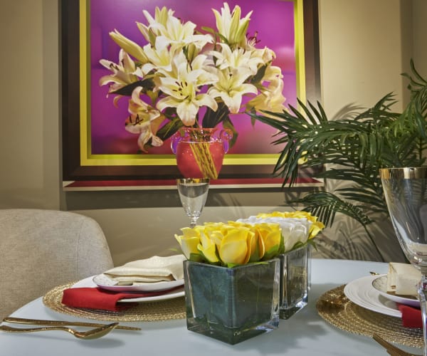 Dining room table with flowers at All Seasons of Rochester Hills in Rochester Hills, Michigan