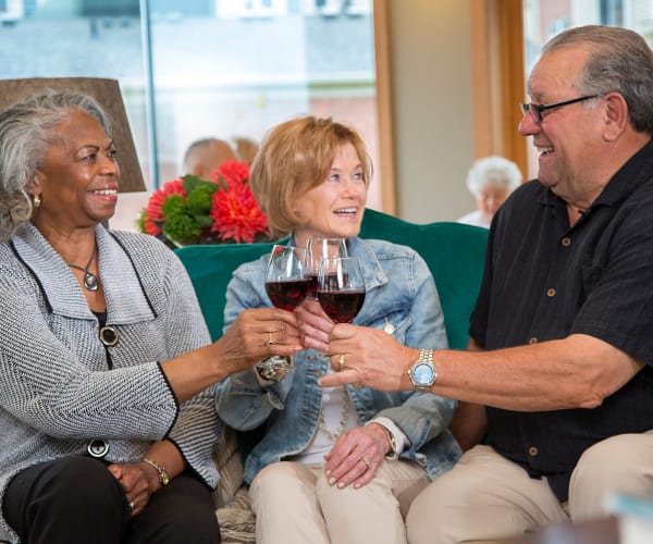 Residents chatting over some wine at All Seasons Rochester Hills in Rochester Hills, Michigan