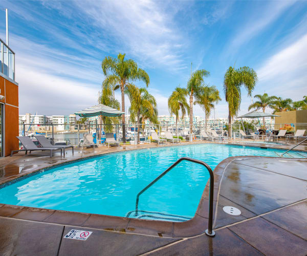 Beautiful pool and outdoor seating area at Harborside Marina Bay Apartments in Marina del Rey, California