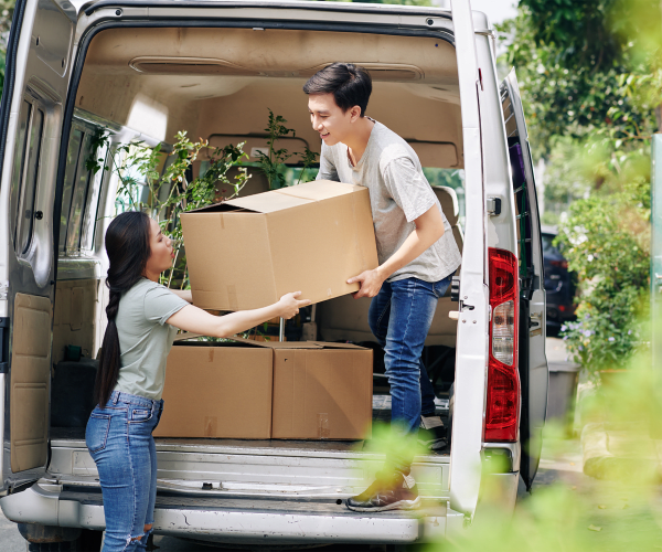 A white free moving van with two movers. A Super Move with One girl and one guy unloading at 21st Century Storage in Long Island City, New York