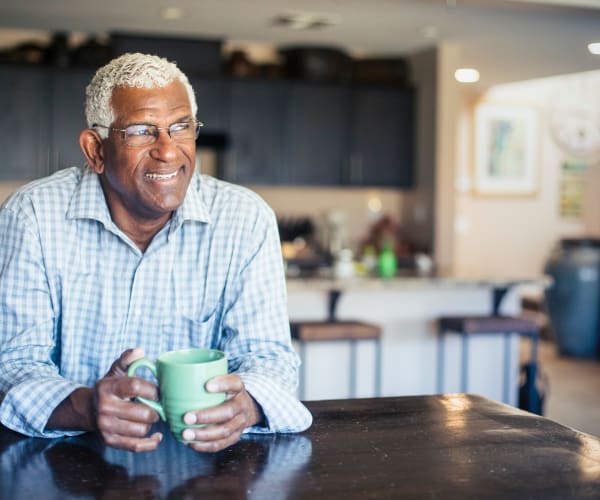 a resident enjoying some coffee at home at Park Summit in San Diego, California