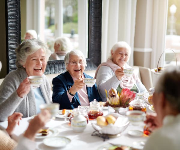 Residents dining and laughing at Lake Park Senior Living in Oakland, California