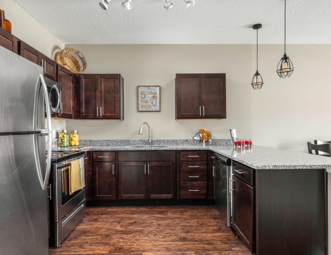 Open-concept layout with hardwood flooring in a model home at Bonterra Apartments in Fort Wayne, Indiana