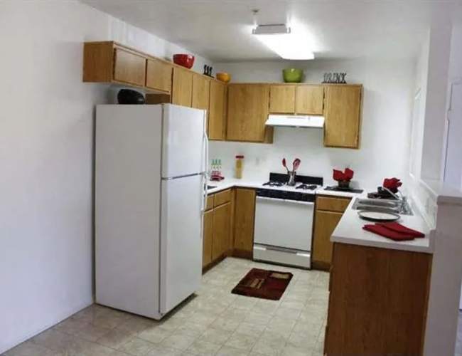 Kitchen with white color appliance at Casa Bella in Victorville, California