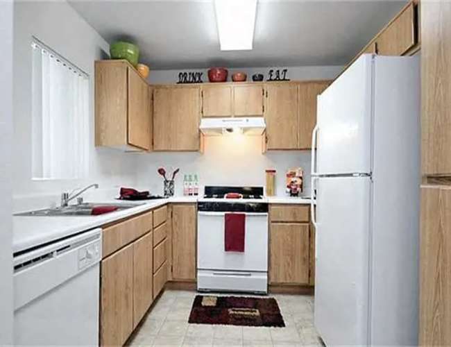 Kitchen with dishwasher and window at Casa Bella in Victorville, California