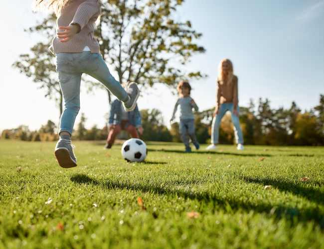 Resident family playing in playground at Villa Encantada in San Diego, California