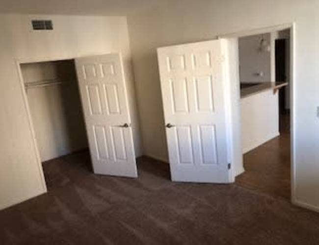 Unfurnished bedroom with closet and entry door near kitchen at Oceana Apartments in , California