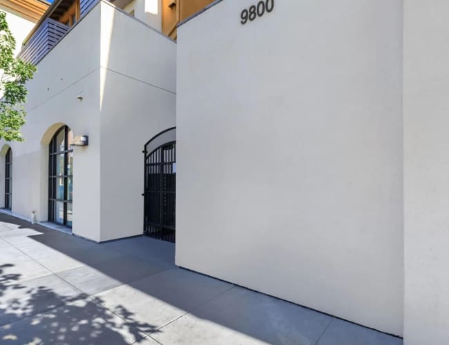 Exterior front entrance view at MacArthur Apartments in Oakland, California