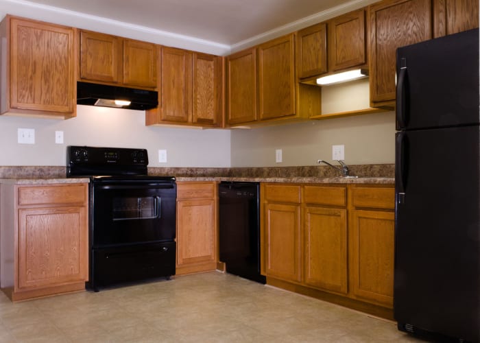 An apartment kitchen with black appliances at Carriage House Apartments in Smyrna, Georgia