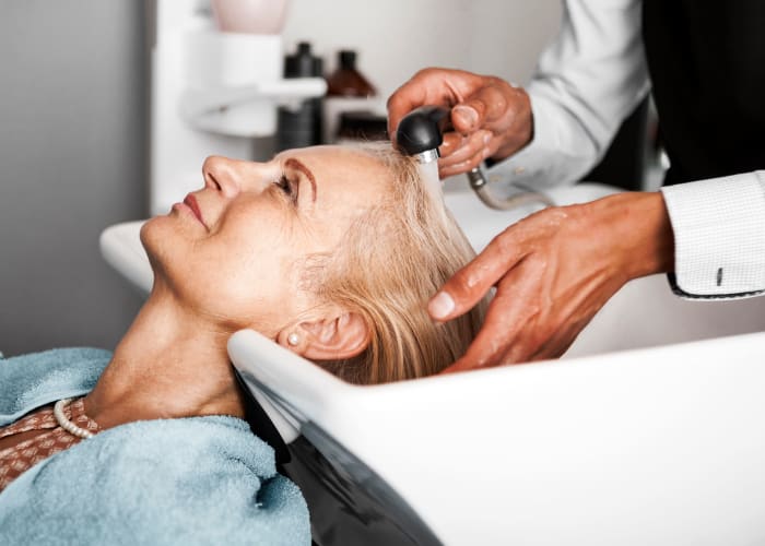 A woman having her washed at the on site salon at Westminster Memory Care in Aiken, South Carolina