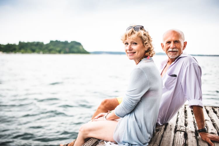 Couple sitting on dock near Arbor Landing at Pawleys in Pawleys Island