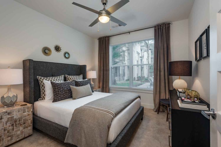 Closeup of well-decorated bed in model home at The Jaxon in Jacksonville