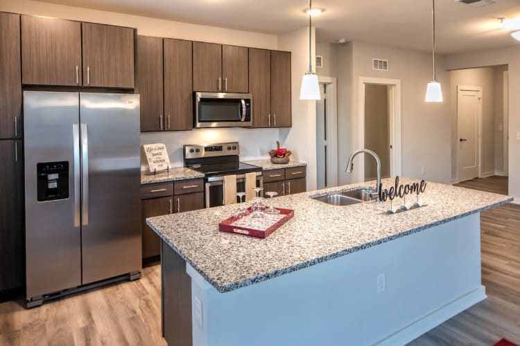 Modern living room leading to fully equipped open kitchen at Luxor Club in Jacksonville, Florida
