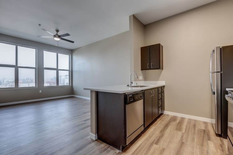 Open-floor layout with a ceiling fan in living room at Lumen Apartments in Everett, Washington