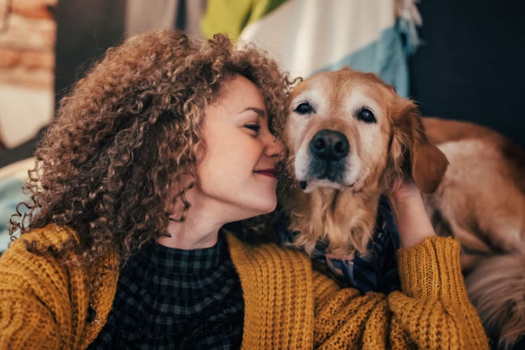 Resident and her dog loving their new home at Sage at 1825 Apartments in Pflugerville, Texas